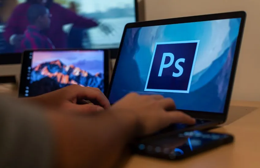 Trabajador utilizando Adobe Photoshop con su portátil del kit digital para autónomos.